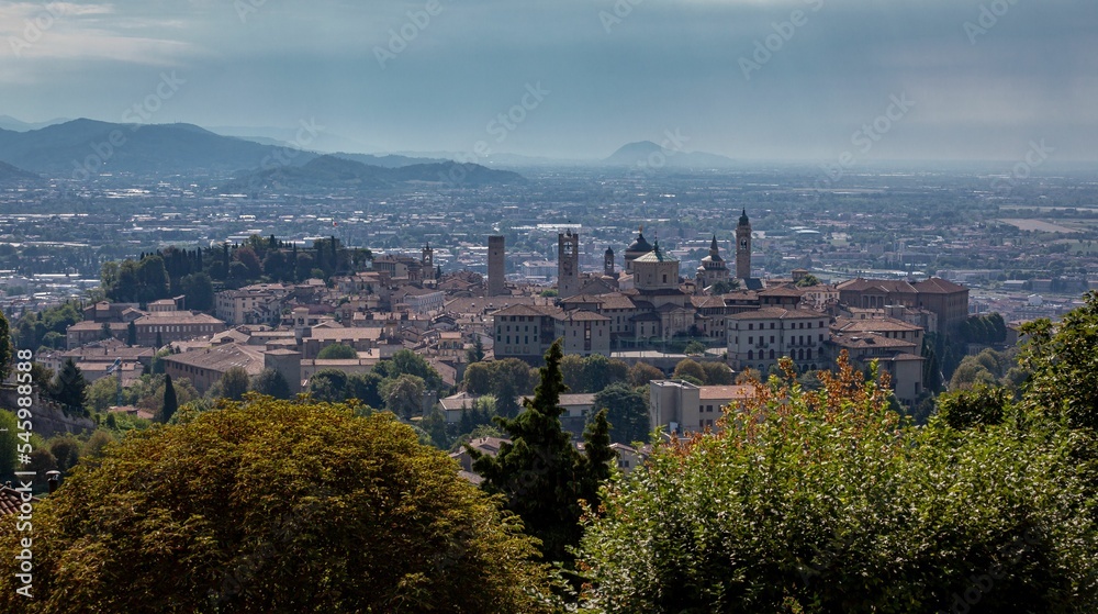 Skyline of Bergamo, Spain with trees in front on a sunny day