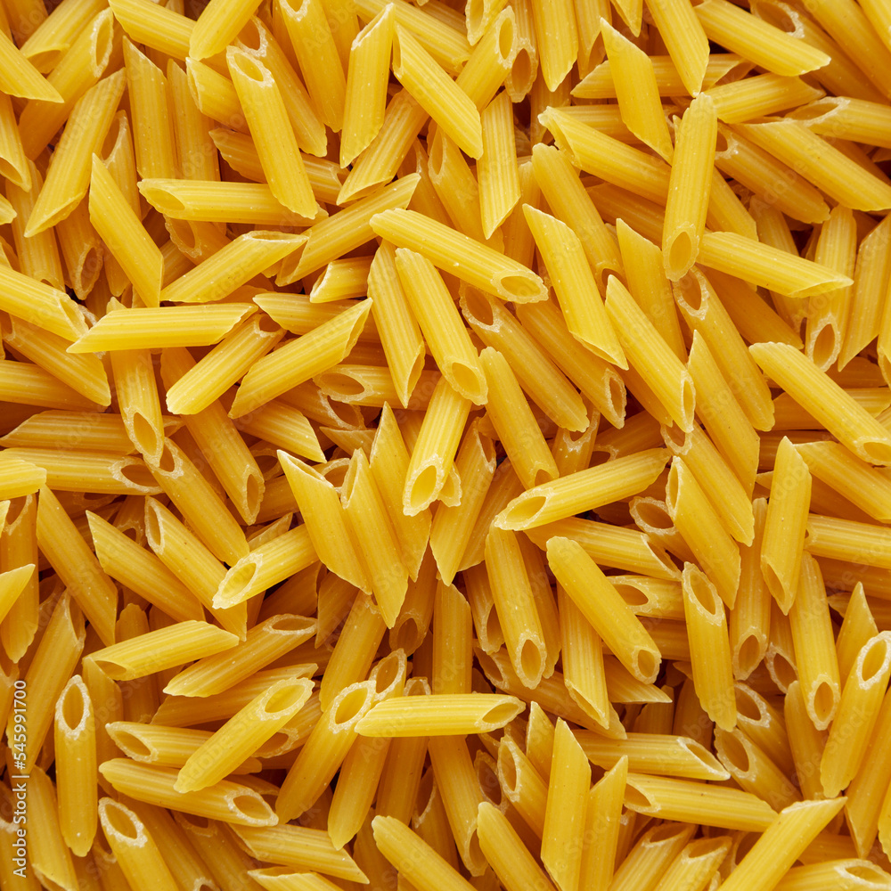 Homemade Raw Dry Mini Penne Pasta background Homemade Raw Dry Mini Penne Pasta background