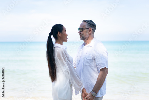 Romantic Couple Walking on the Beach. portrait of living young couple at the beach. Romantic marriage proposal at the seaside on the beach sea. Romantic marriage proposal on the beach.