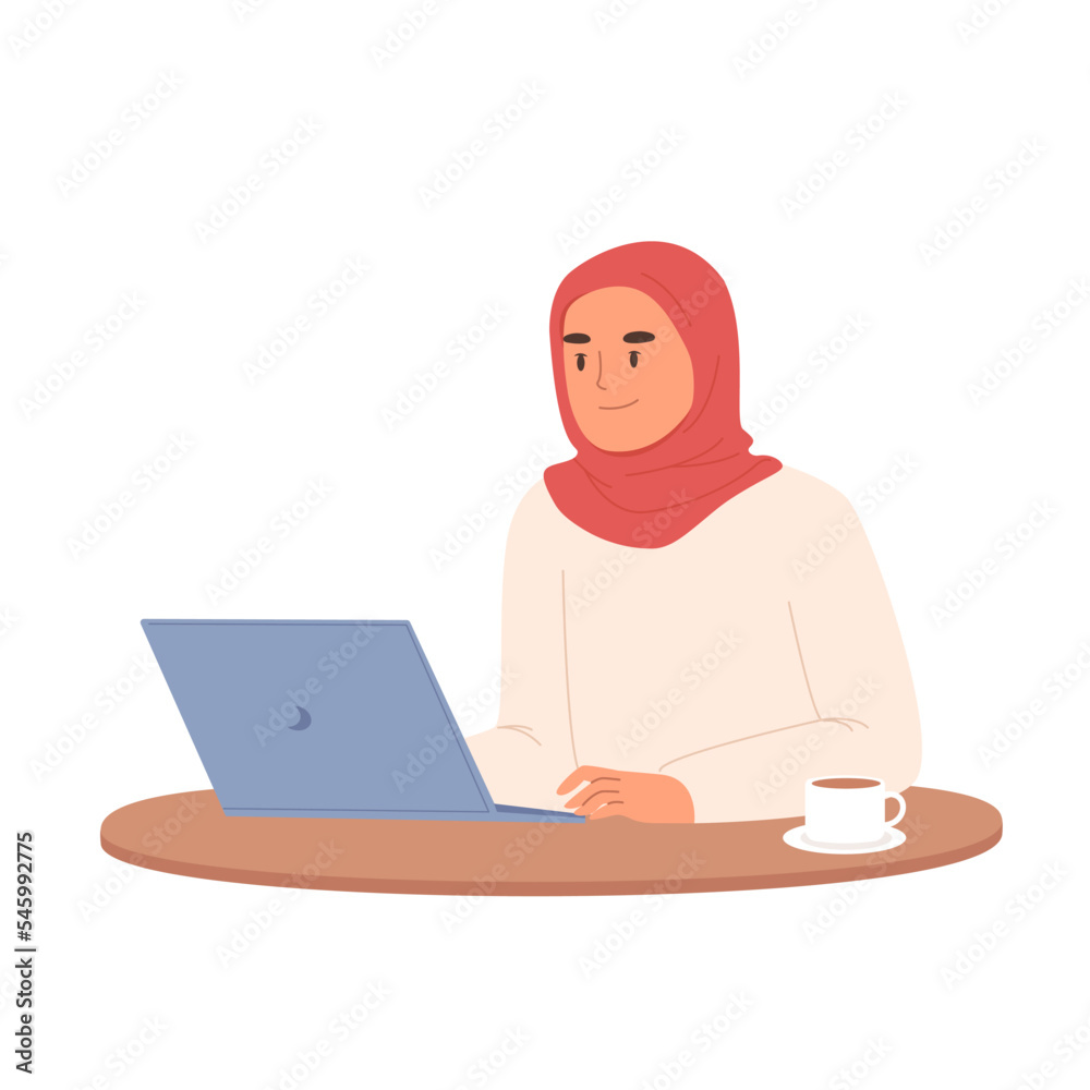 Woman in hijab working or studying on laptop on table with cup of coffee. Student or freelancer muslim woman.