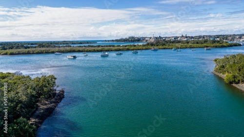 Aerial view of boats and ships in Hastings River and lush green forests in Port Macquarie, Australia