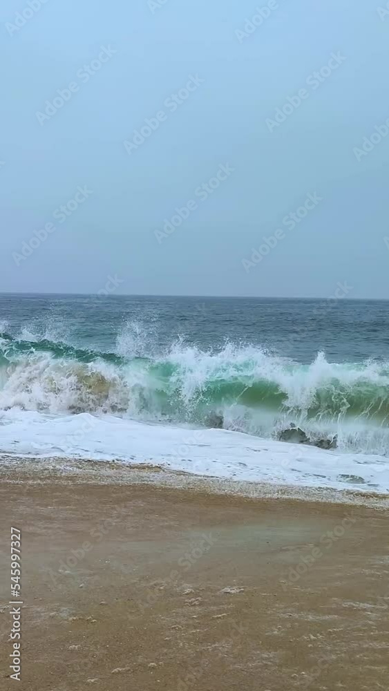 Vertical daytime view of the beach on Nazare, Portugal Vertical daytime view of the beach on Nazare, Portugal