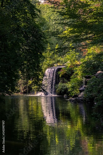 Vertical shot of a waterfall in Bois de Vincennes in Paris, France