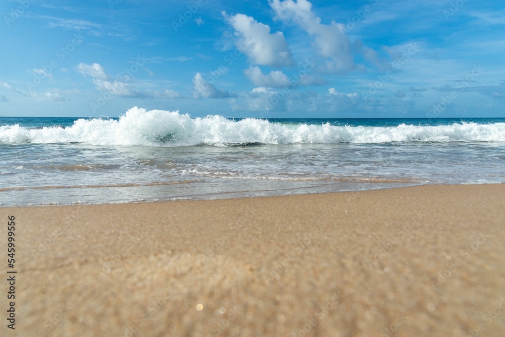 View of sandy beach with foamy waves against blue sky with clouds in background. Barra beach, Brazil View of sandy beach with foamy waves against blue sky with clouds in background. Barra beach, Brazil