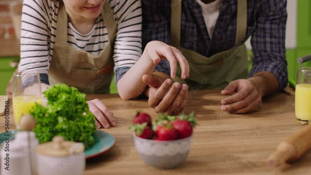 At the kitchen island closeup to the camera multiracial couple hugging hands and touching very romantic each other with passion