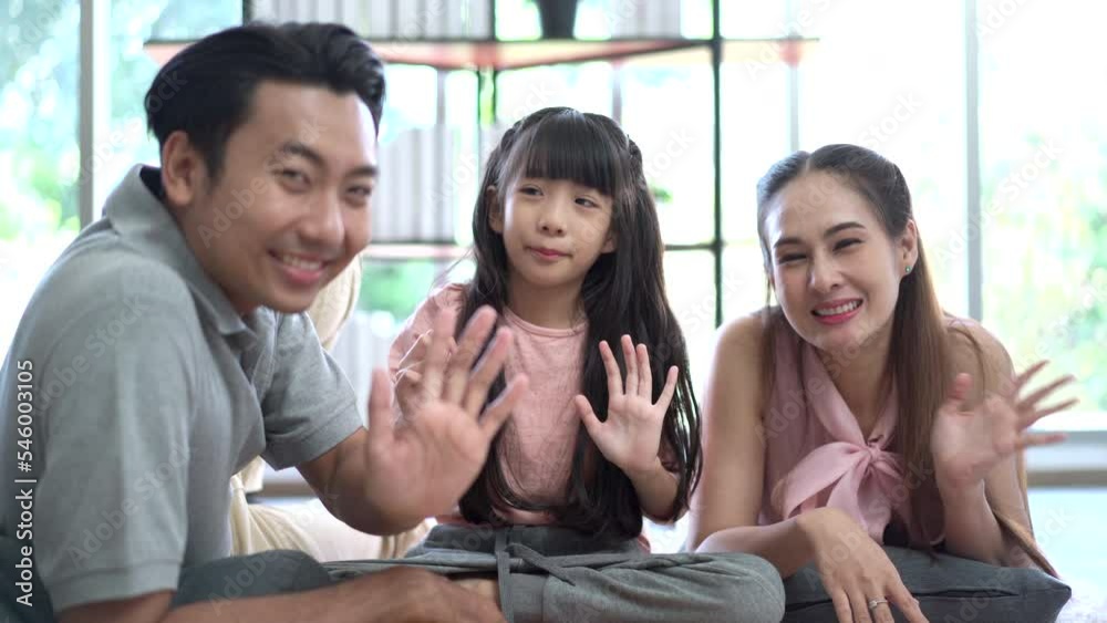 Happy Asian family, father, mother, and daughter living together in the living room. Happy Asian family, father, mother, and daughter living together in the living room.
