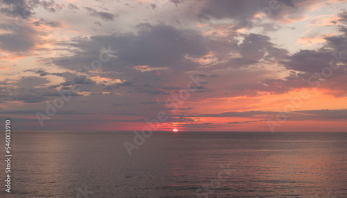 Fototapeta Naklejka Na Ścianę i Meble -  Calm sea with sunset sky with cloud.