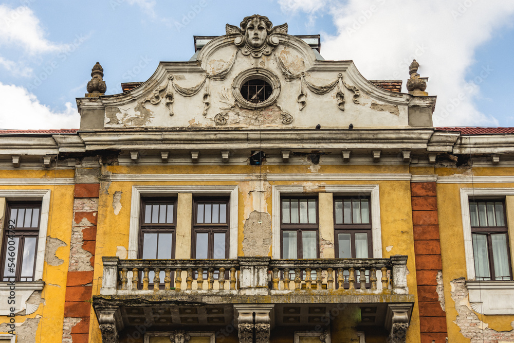 Fototapeta premium Aged vintage historic building with missing pieces. Old European architecture