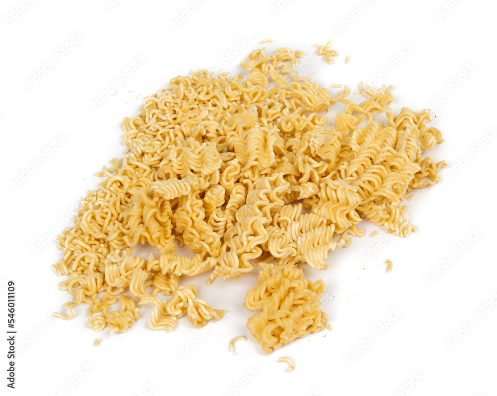 crumbled briquette of dry instant noodles on a white background crumbled briquette of dry instant noodles on a white background