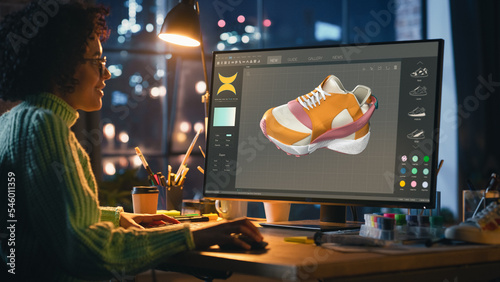 Black Teenage Woman Creating and Rendering 3D Model of Unique Sneaker on Powerful Personal Computer, Working in the Evening. Freelance and Talented Millennial People Concept.
