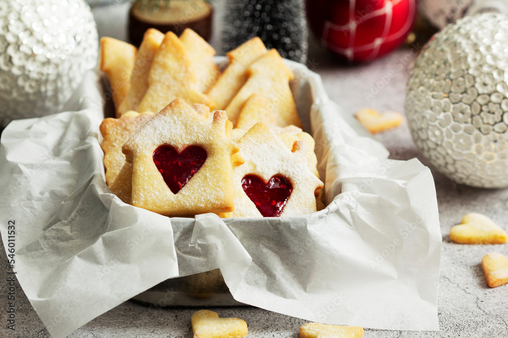 Sugar cookies stuffed with raspberry jam on a light background. Christmas and New Year's decor.