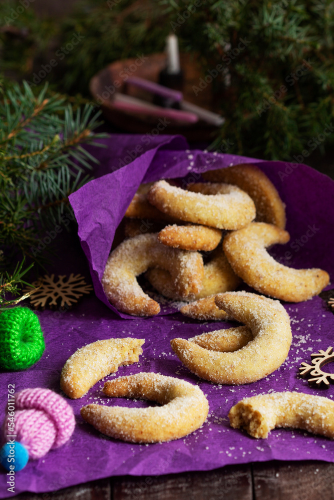 Traditional advent cookies vanilla crescents on a purple background. Rustic style.