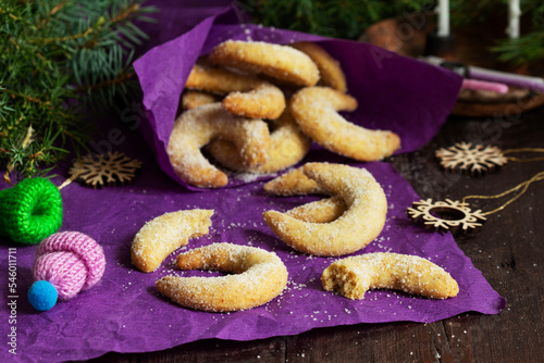 Traditional advent cookies vanilla crescents on a purple background. Rustic style.