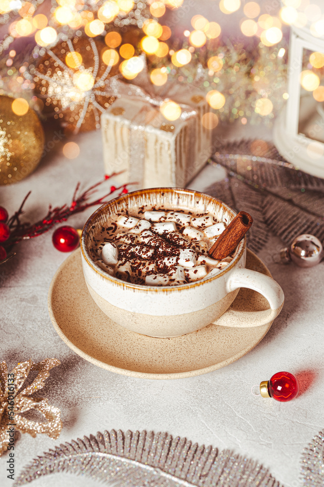 A cup of cocoa with marshmallows on a New Year's table on a white background. Cozy Christmas vertical card