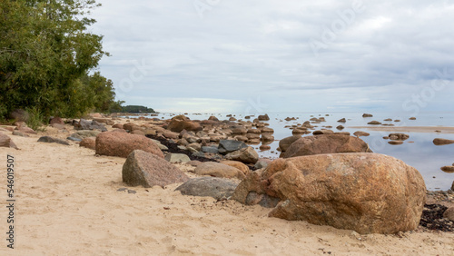 Sea view with blue sky, various rocks and green trees