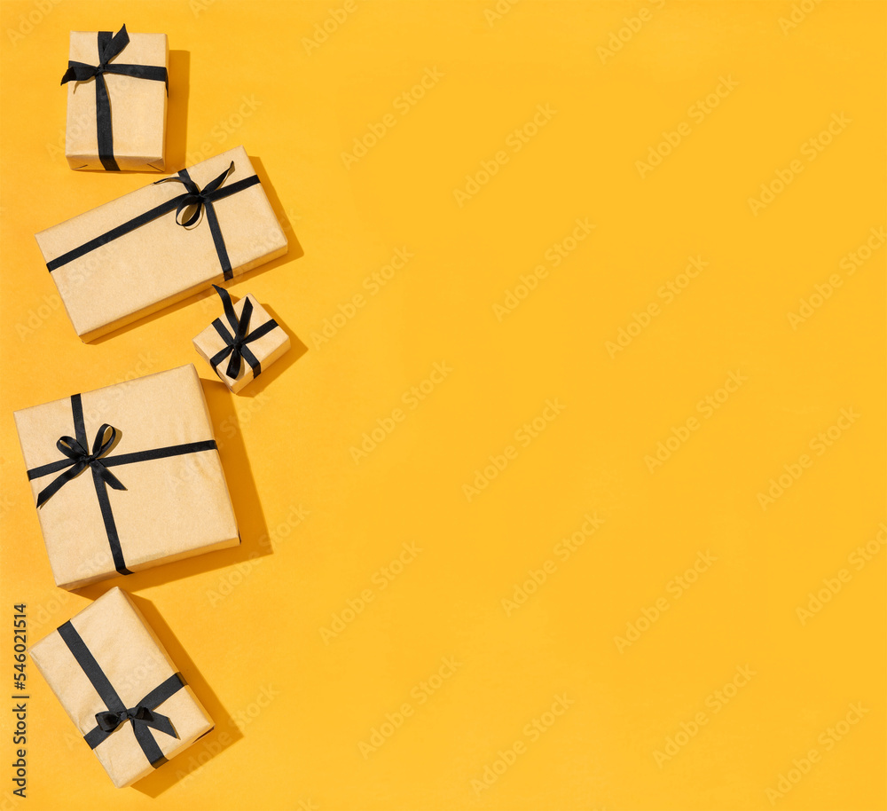 Set of Gift boxes with black ribbon on yellow background.