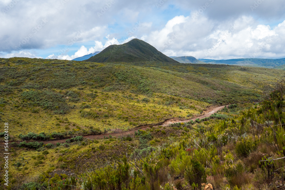 A dirt road against a mountain background at Chogoria Route, Mount Kenya