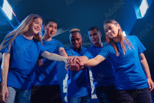 Multi cultural team gamers caucasian, african, asian of professional online video game players hands together. Concept tournament cyber esport