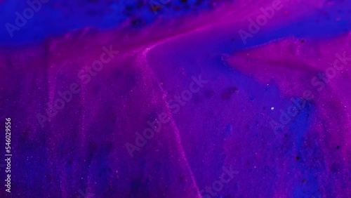 Fluid magic. Creative art. Cosmic painting. Purple blue stream of liquid paint with shimmering glitter floating timeless texture in macro shooting. photo