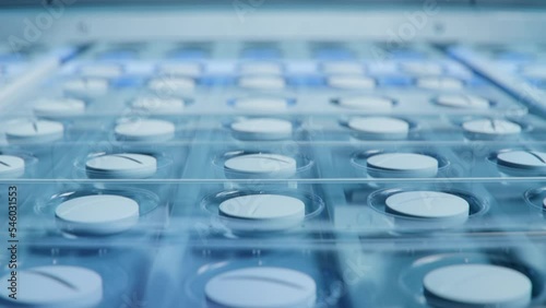 Close-up Shot of White Pills During Production and Packing Process on Modern Pharmaceutical Factory. Medical Drug Manufacturing.