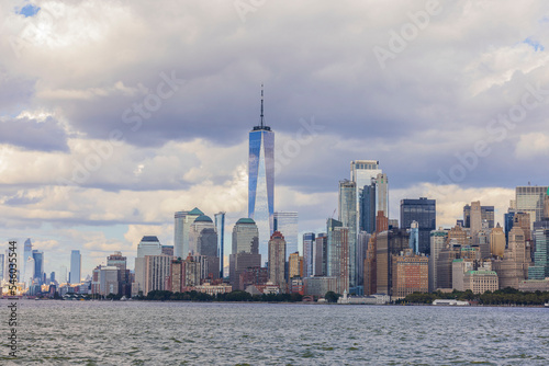 Beautiful panoramic view of skyscrapers of Manhattan from Hudson River under blue sky with white clouds. New York, USA.
