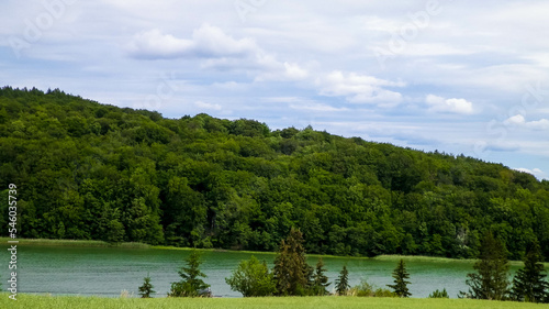 Field and Ostrzyckie Lake in a background. Nature of Wiezyca  Poland.