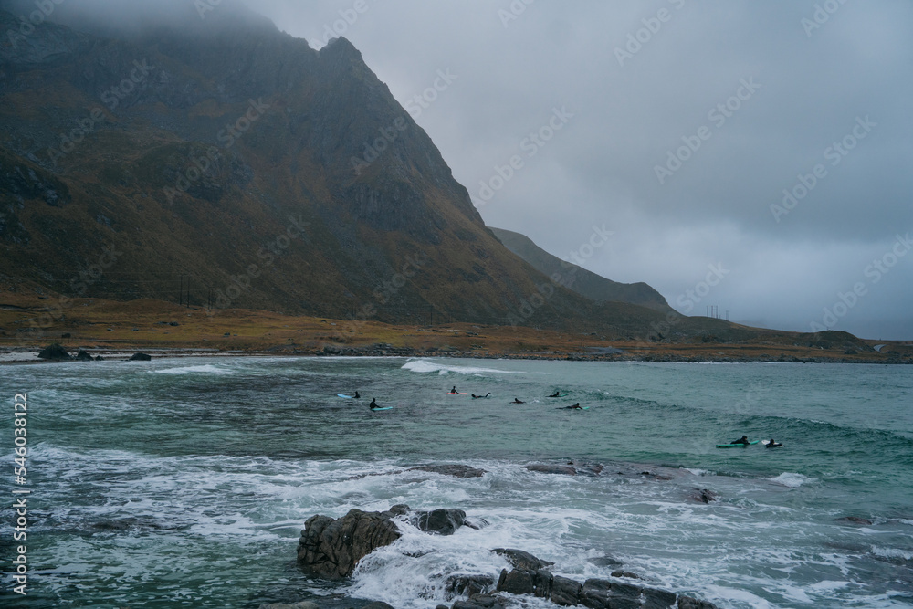 Surfer are training on the Skagsanden beach of the Lofoten Islands Surfer are training on the Skagsanden beach of the Lofoten Islands