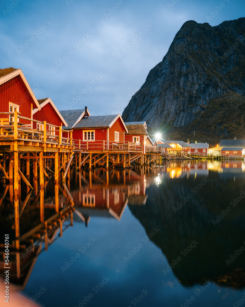 Fototapeta premium Reine at night, Lofoten, Norway. Traditional Norwegian fisherman with cabins. Photographed at dawn in autumn or winter.