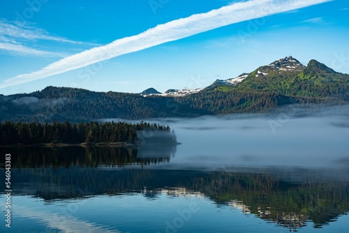 Crystal clear river reflecting scenic mountains and trees, Baranof island, Alaska photo