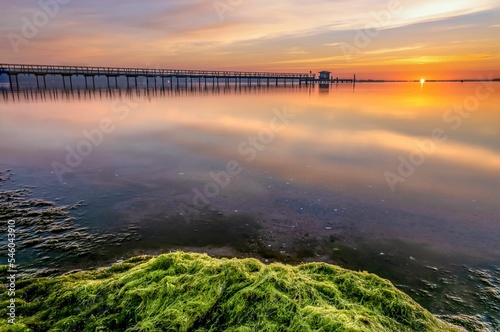 Pier in Harrislee on the Baltic Sea at sunrise with clouds photo