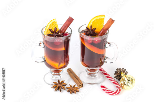 Traditional hot Christmas mulled wine with spices and oranges in mugs on a white background