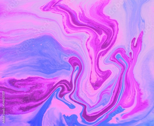 Lilac-pink marble background pattern. Acrylic paint flows freely, mixes and creates an interesting pattern. Bright saturated shades. Background for laptop covers, books, laptop screensavers.