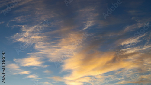 blue sky with golden clouds beautifully illuminated by the sun as a natural background