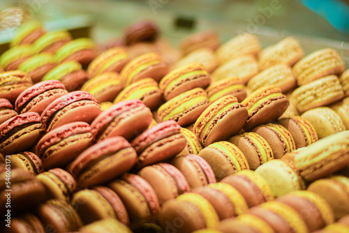 Colorful french macarons being laid on the display