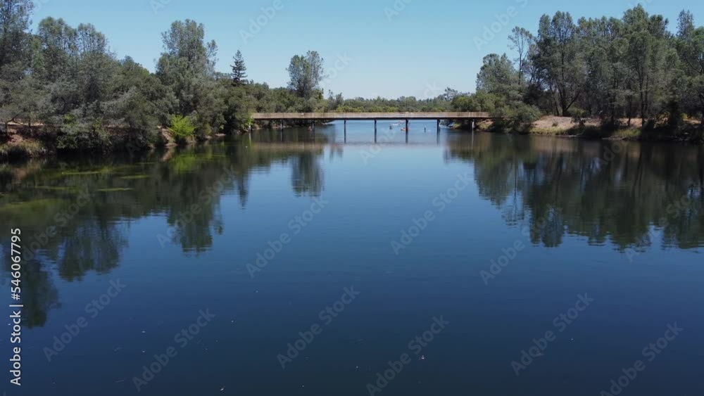 Clear calm lake with wooden bridge Clear calm lake with wooden bridge
