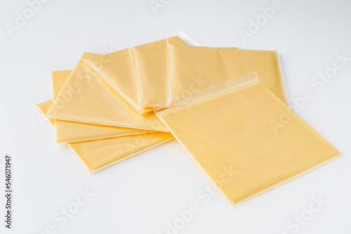 slices of American cheddar cheese on a white background