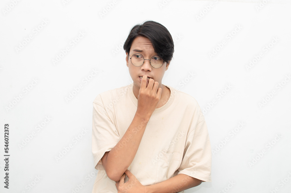 Thoughtful confused asian man thinking and wondering to choose something isolated over white background. man feeling uncertain and unsure. Thoughtful confused asian man thinking and wondering to choose something isolated over white background. man feeling uncertain and unsure.