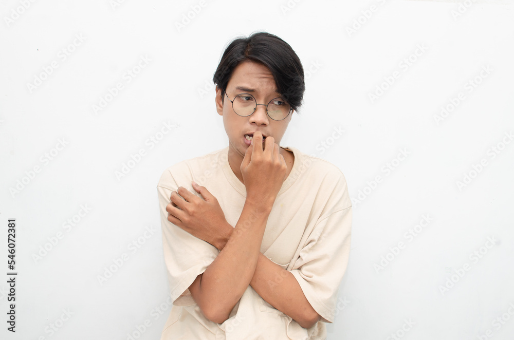 Thoughtful confused asian man thinking and wondering to choose something isolated over white background. man feeling uncertain and unsure. Thoughtful confused asian man thinking and wondering to choose something isolated over white background. man feeling uncertain and unsure.