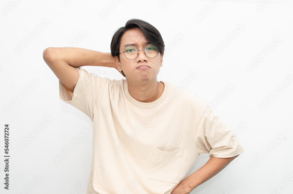 Thoughtful confused asian man thinking and wondering to choose something isolated over white background. man feeling uncertain and unsure.