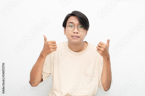 Thoughtful confused asian man thinking and wondering to choose something isolated over white background. man feeling uncertain and unsure.