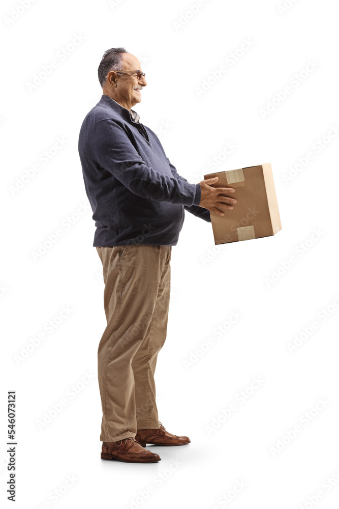 Full length profile shot of a mature man holding a cardboard box Full length profile shot of a mature man holding a cardboard box