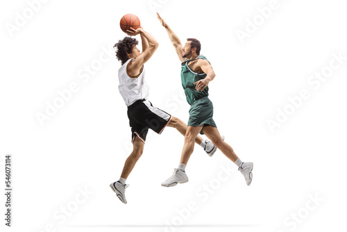 Basketball player jumping and performing blocking to another player
