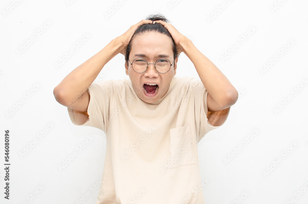 asian man looks depressed and messed up. Irritated man bites lips and scratches head. stressed over work concept. asian man looks depressed and messed up. Irritated man bites lips and scratches head. stressed over work concept.