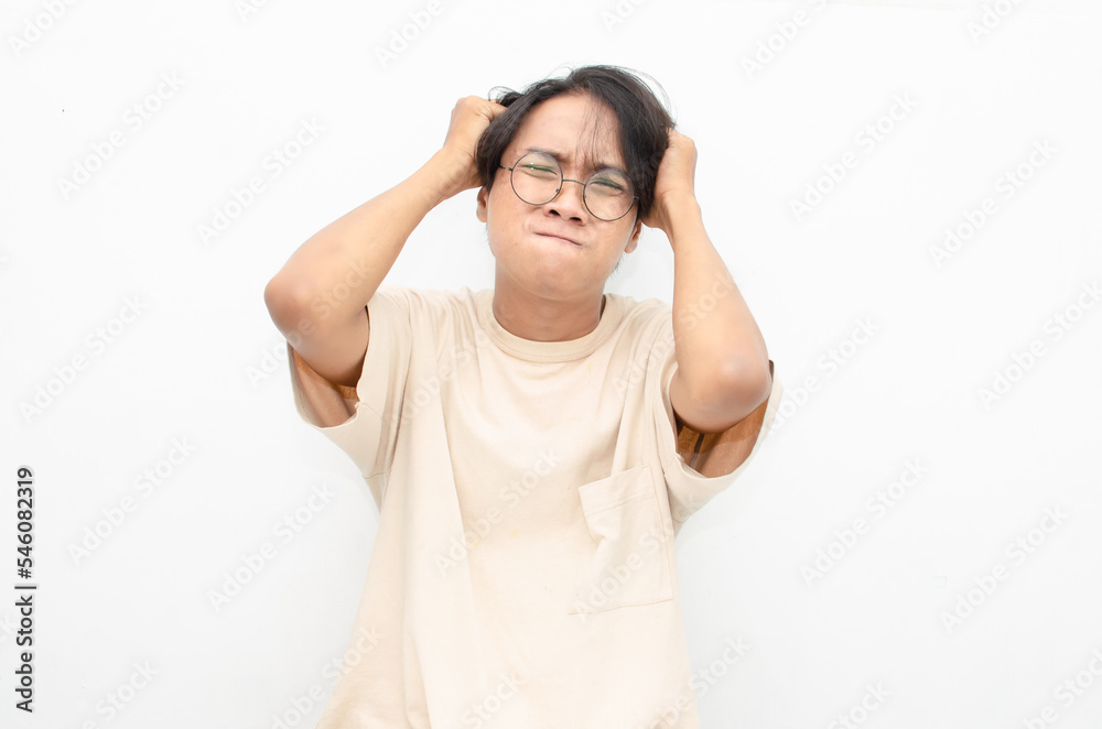 asian man looks depressed and messed up. Irritated man bites lips and scratches head. stressed over work concept. asian man looks depressed and messed up. Irritated man bites lips and scratches head. stressed over work concept.