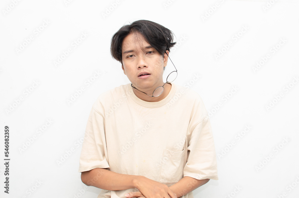 asian man looks depressed and messed up. Irritated man bites lips and scratches head. stressed over work concept. asian man looks depressed and messed up. Irritated man bites lips and scratches head. stressed over work concept.