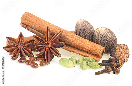 Christmas spices - anise stars, cardamom pods, nutmeg, cloves and cinnamon sticks on a white background.