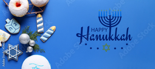 Photos Greeting card with symbols of Hanukkah and Christmas decor on blue background