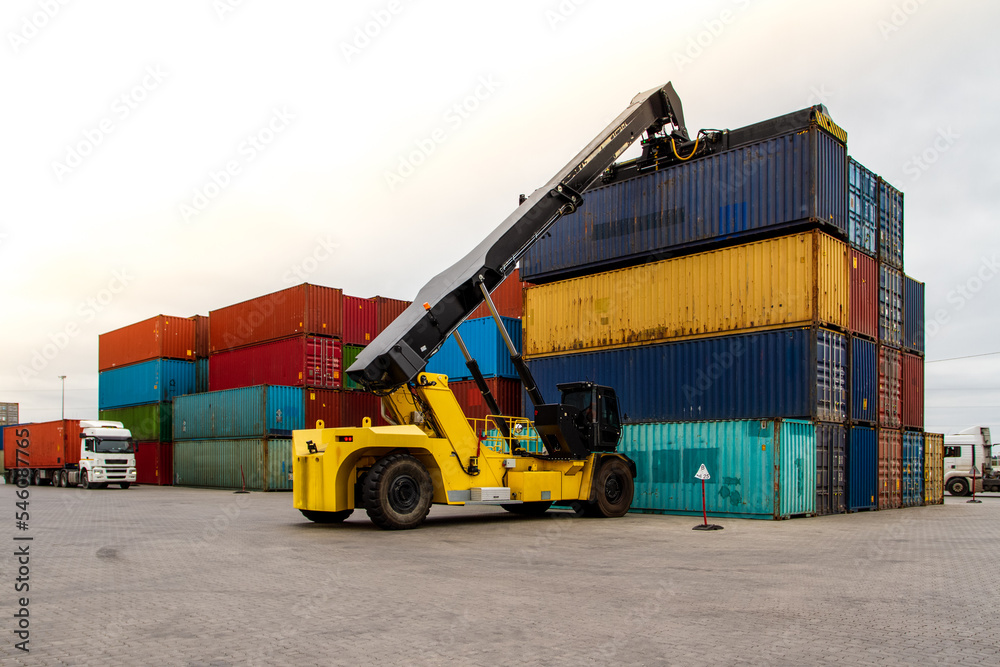 Forklift handling cargo container. Freight container loading. Container handler.  Logistics import export concept. Industrial container logistic yard.