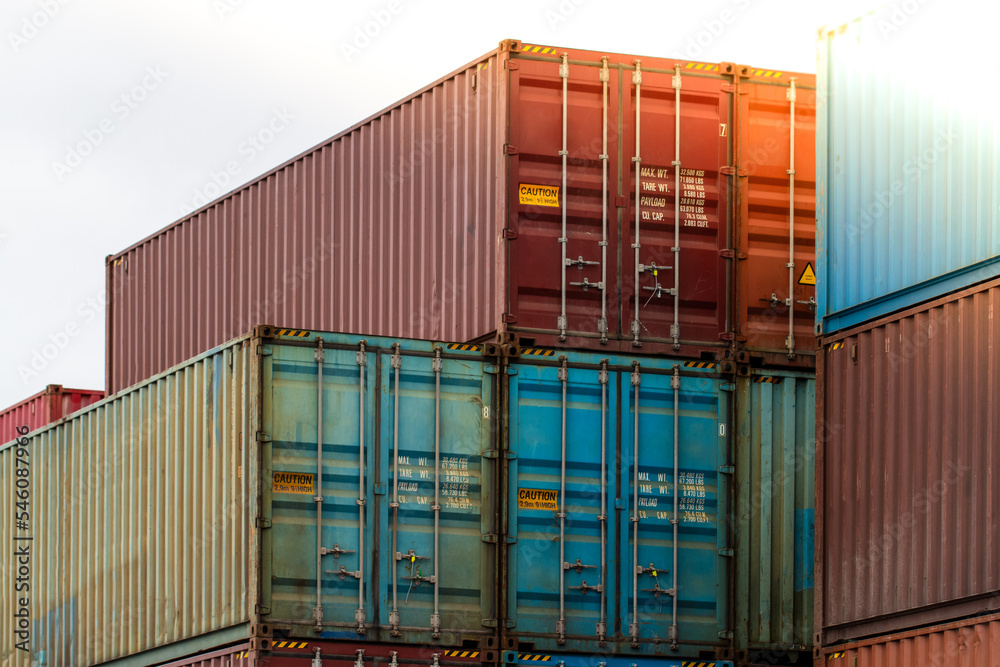 Fototapeta premium Cargo containers. Cargo container yard. Stack of freight containers at the docks. Industrial yard. Import and export logistic concept.