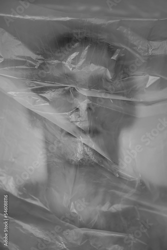 Man behind plastic curtain. Prohibition, restriction, feeling stuck, depression concept photo